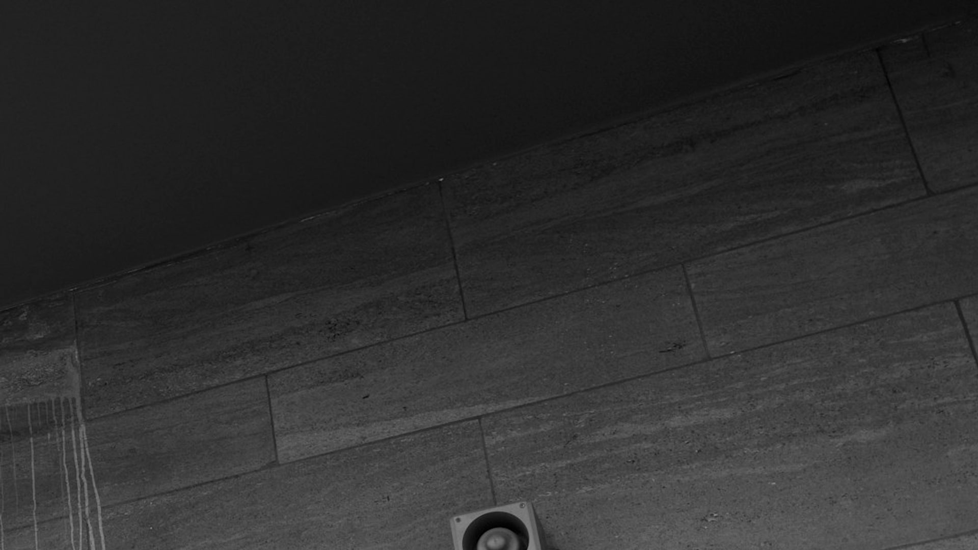 Close-up of PTZ CCTV camera covering warehouse yard fence line